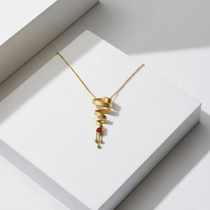 14k Gold Earrings With Spiral Pattern And Red Stone