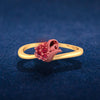 14K gold ring with a rose motif adorned with red stones