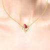 14K gold pendant with stone-studded rose entwined in a leaf design 