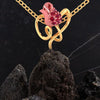 14K gold pendant with stone-studded rose entwined in a leaf design 