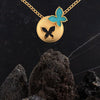 14K spherical gold pendant adorned with a butterfly on top and a hollowed-out butterfly in the center  