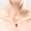 14K gold necklace with double hearts on a stone-studded tulip and a pearl drop 