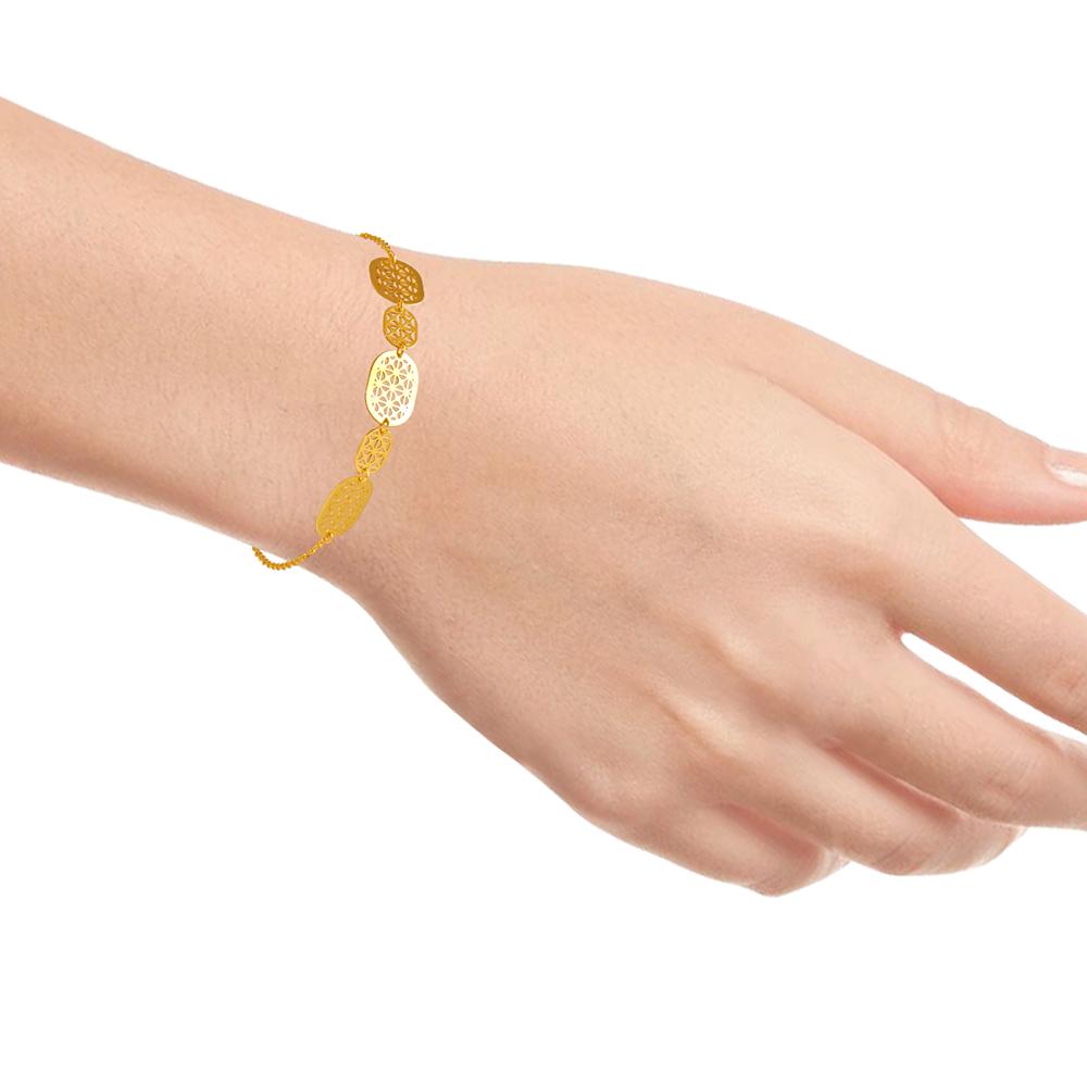 22K gold bracelet with a string of ovals having geometric patterns