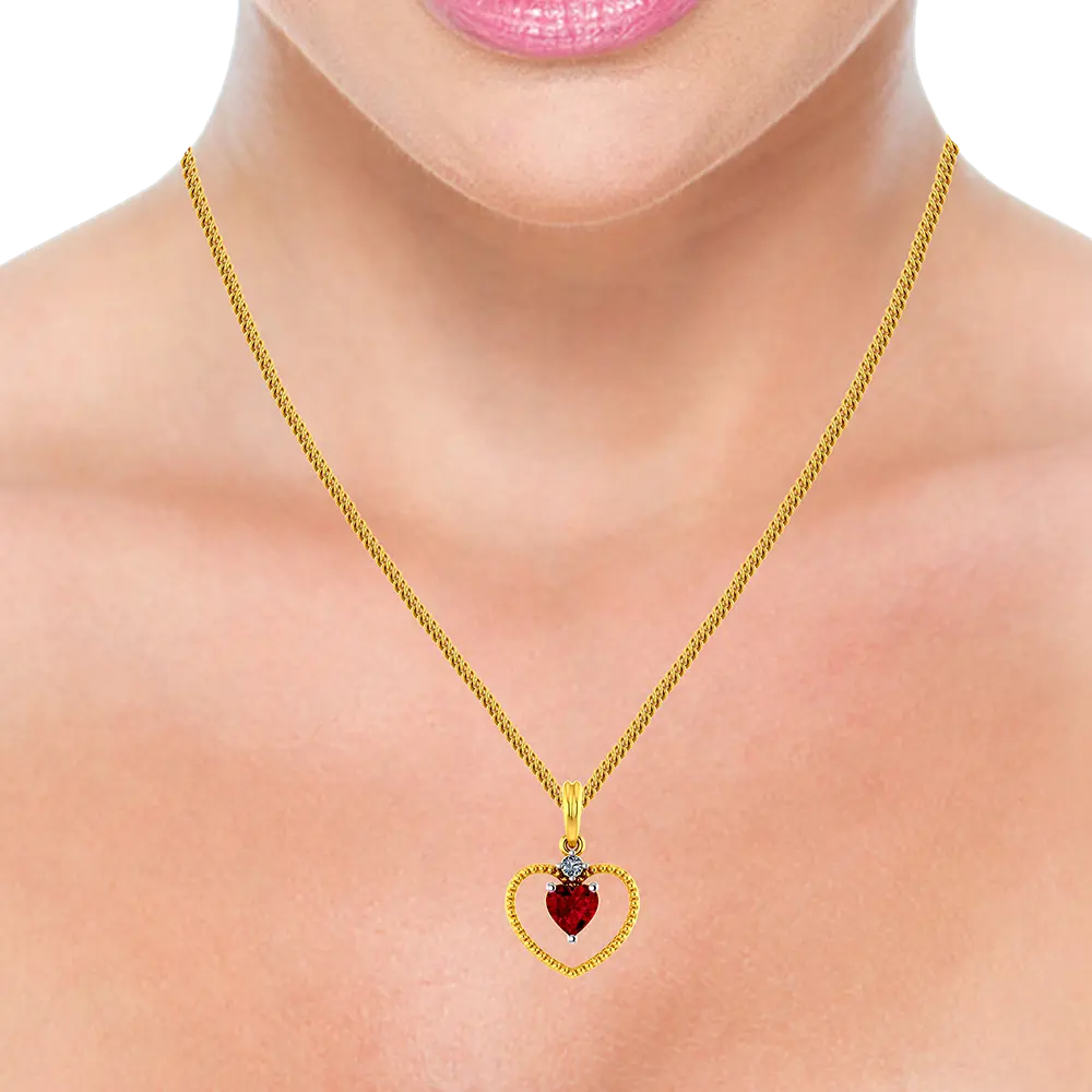 22K Heart shaped gold pendant with a red heart shaped stone in the middle